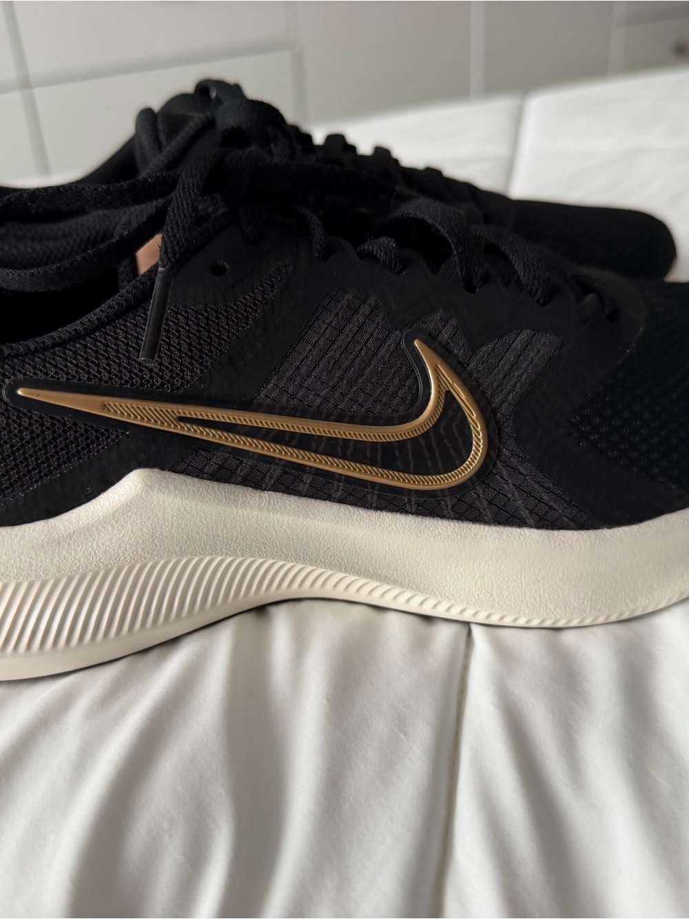 Nike Men’s Black Athletic Shoes with Gold Swoosh
